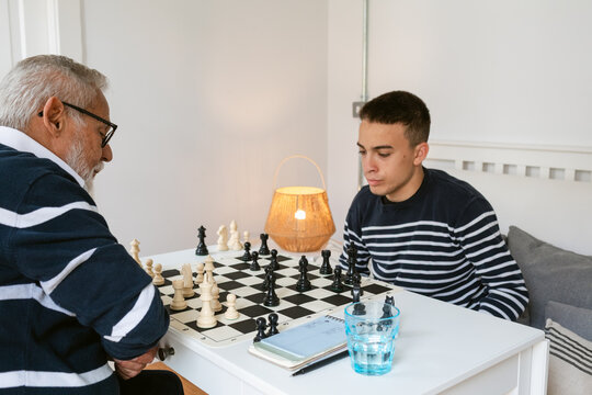 Chess Match Between a Grandfather and Grandson