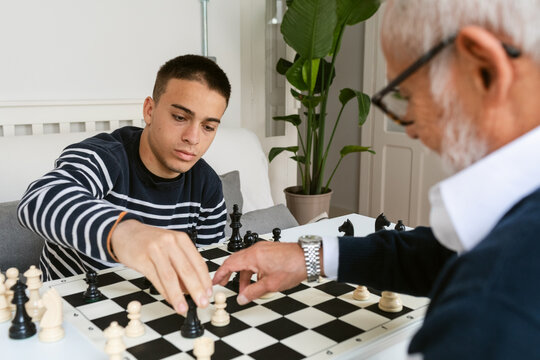 Grandson and Grandfather play chess