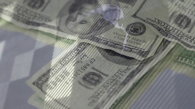 US $100 bill entering frame, camera moving closer, bills stacking and settling for glossy demo