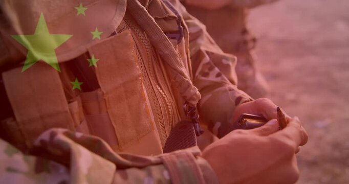 Soldier torso hands in sunset light, starting reaching, extracting, checking round near vest flag