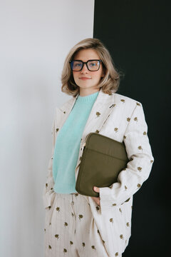 Confident Woman in Suit With Laptop Case