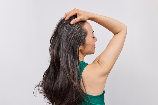 Asian woman with long dark hair in studio