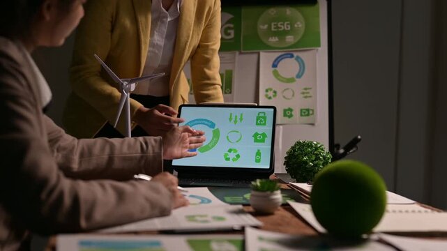 Businesswomen presenting esg circular economy report on tablet