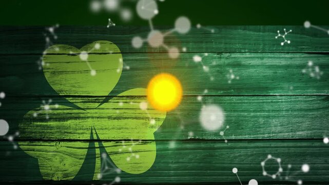 Green glow at right of shamrock sparking yellow red orbs rising dots drifting to highlight shamrock