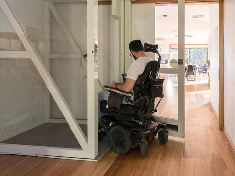 Wheelchair User Enters a Modern Home Lift for Accessibility