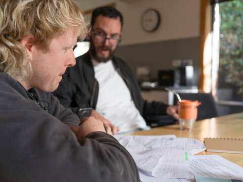 Disabled man applying for NDIS support with help from support worker