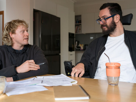 Support worker assists clients with NDIS application at home