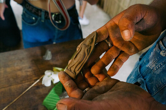 Handmade Buddha amulet from clay in a cultural workshop in Thailand