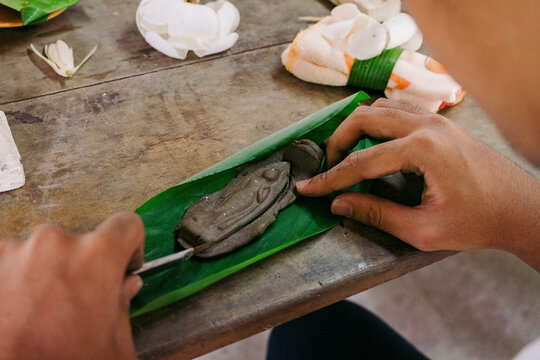 Handmade Buddha amulet from clay in a cultural workshop in Thailand