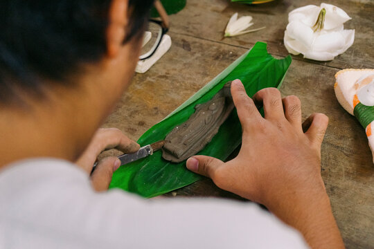 Handmade Buddha amulet from clay in a cultural workshop in Thailand