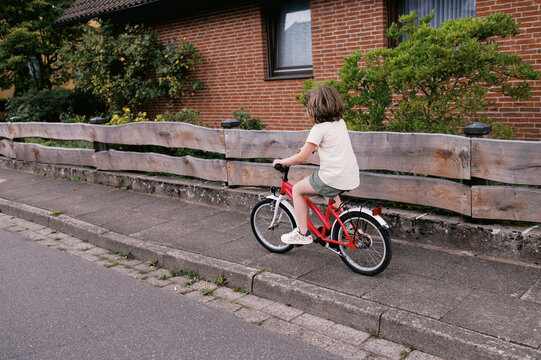 backside view of little girl on bike in Germany