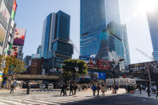 Shibuya Scramble Crossing, Tokyo, crowd of pedestrians and tourists walking on pedestrian crossing intersection during rush hour, Shibuya Station, Tokyo, Japan, passer-by walk in a sunny day