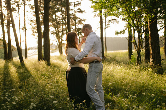 portrait of young happy couple dancing in nature in Auvergne, France
