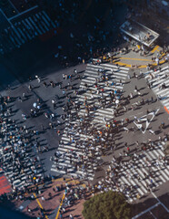 Fototapeta premium Shibuya Scramble Crossing, Tokyo, crowd of pedestrians and tourists walking on pedestrian crossing intersection during rush hour, Shibuya Station, Tokyo, Japan, passer-by walk in a sunny day
