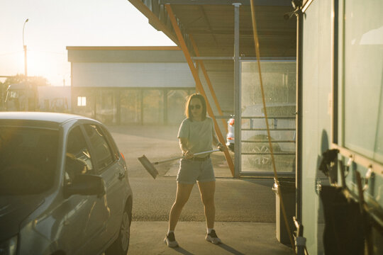 Woman focused on washing car