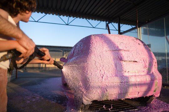 Family washing car at self service