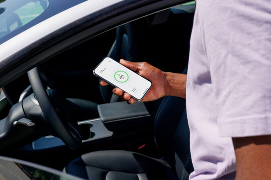 EV Charging App Displayed Beside Modern Car
