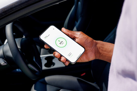 Electric Car with Phone App Showing Charging Status 