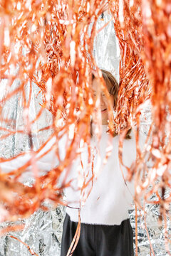 Smiling girl surrounded by shiny decorations