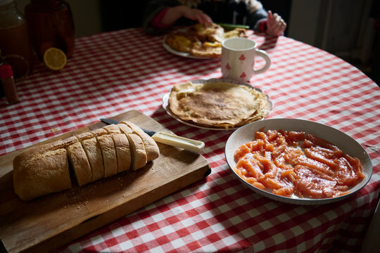 Freshly sliced bread and delectable dishes on a checkered table
