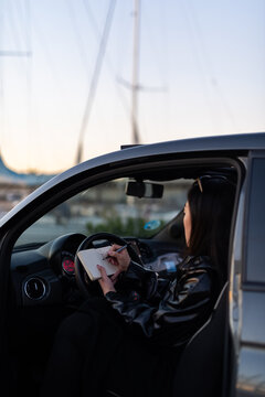 Artist drawing in car