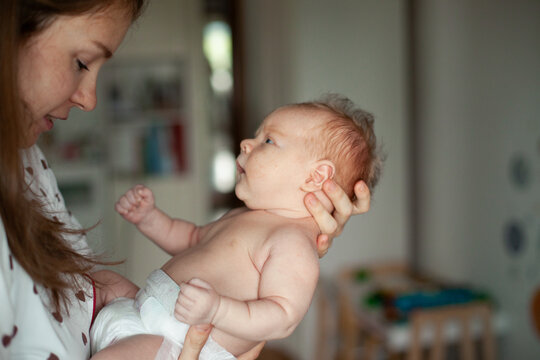 Mother Holding Newborn at Home
