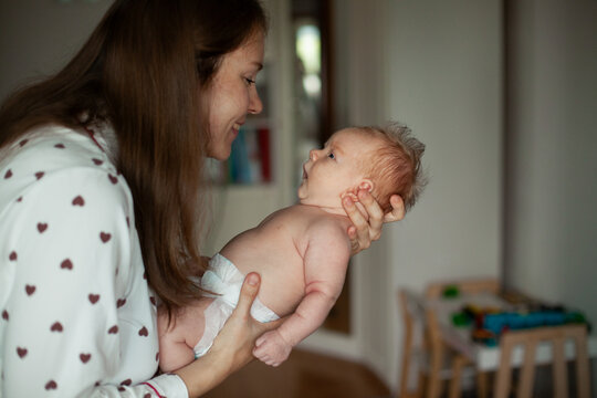 Mother Holding Newborn at Home
