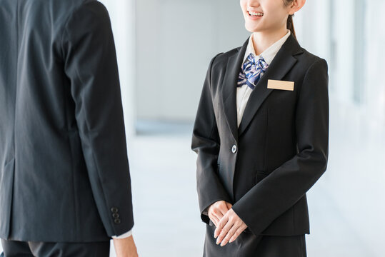 Young Asian businessmen in suits having a conversation in an office corridor