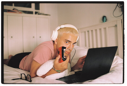 Teen Gaming on Laptop in Bedroom 