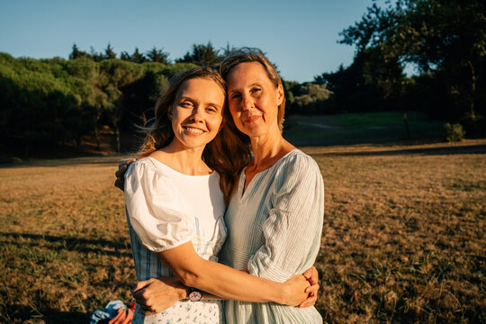 Mother and Daughter Sharing a Joyful Moment in a Sunny Park