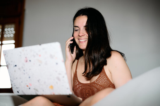 Phone call while working on her laptop