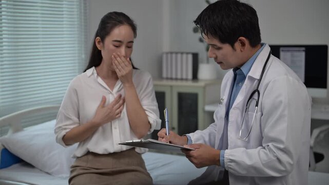 Doctor interviewing coughing patient in hospital room