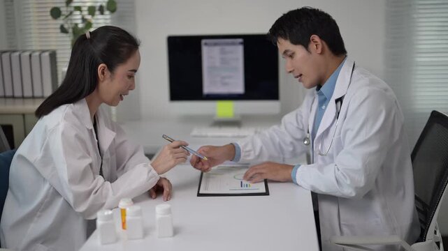 Doctors discussing patient charts and treatment plans in hospital office