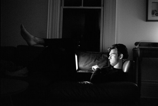 Teen on laptop at night