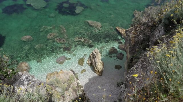 View of the beach with clear water in the bay.