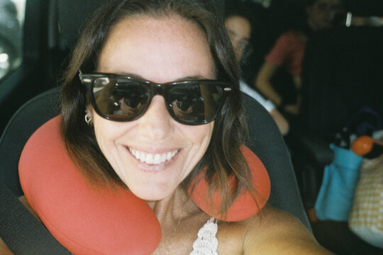 Smiling woman with travel pillow