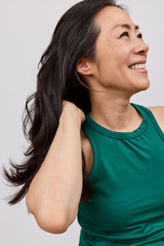 Asian woman with long dark hair in studio