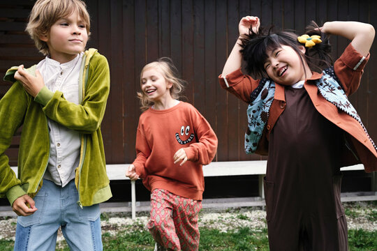 Three children share happiness in an outdoor setting