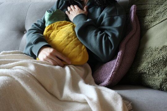 Woman Holding Heating Pad
