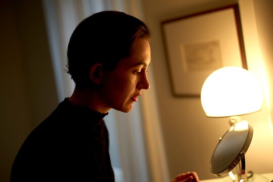 Woman Preparing for the Day in a Softly Lit Room