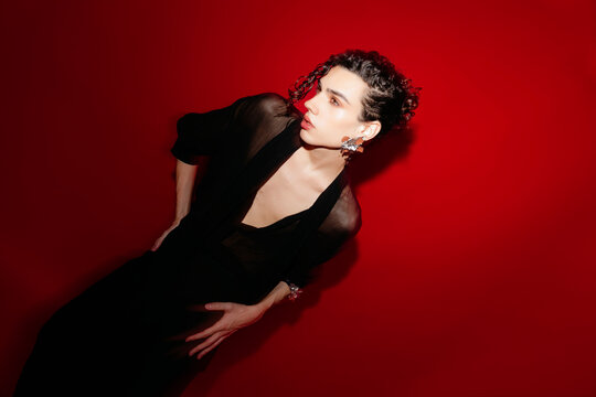 Queer man posing in stylish black outfit