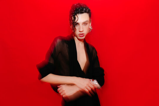 Blurry queer man in studio with flash light