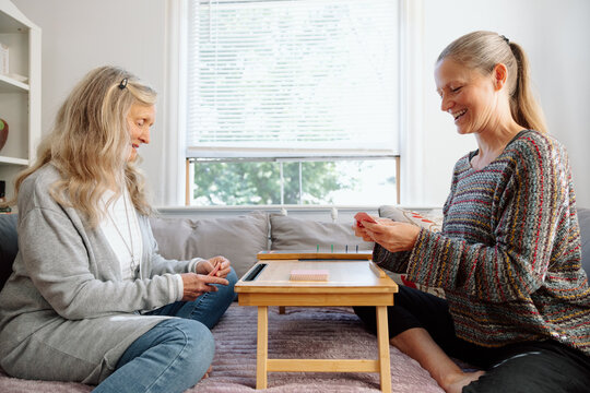 Two friends enjoying a card game indoors in a cozy and relaxed way