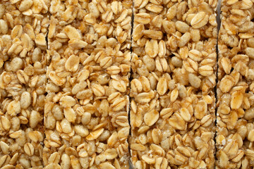 Fototapeta premium A top down view of a row chewy granola bars, as a background.