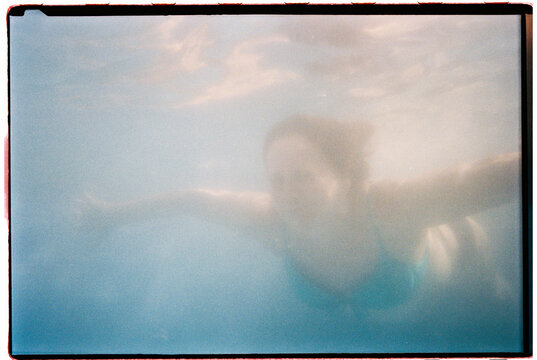 Woman swimming underwater in a pool