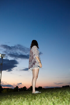 Flash photo of woman with a baby bump at sunset. 