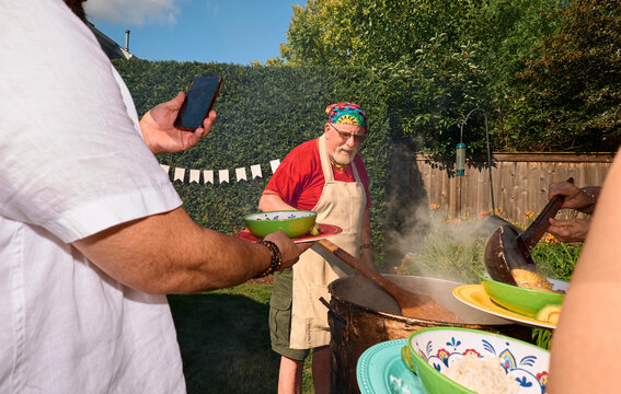Man cooking at backyard barbecue in Chicago
