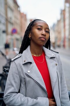 Confident Young Woman Poses on Urban Street in Cool Weather