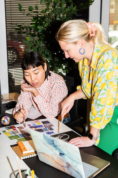 Women discussing design at office 