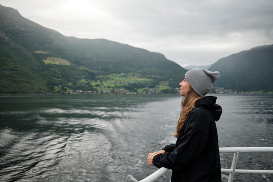 Scenic View of Woman on Boat in Stunning Fjord Landscape